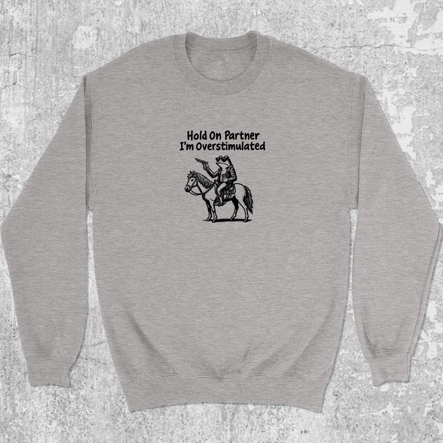 Hold On Partner I'm Overstimulated graphic sweatshirt with funny frogs print, warm and cozy graphic for everyday wear. Perfect for Christmas gifts for friends and family. Heather Grey pullover.