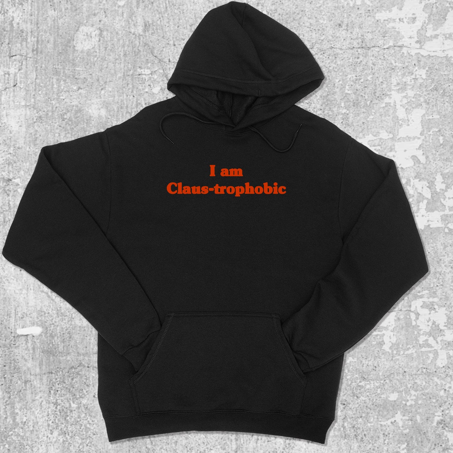 I'm Claus-trophobic graphic hoodie with funny and trendy artwork, casual streetwear with bold personality. Great for adults and gifting. Black hoodie.