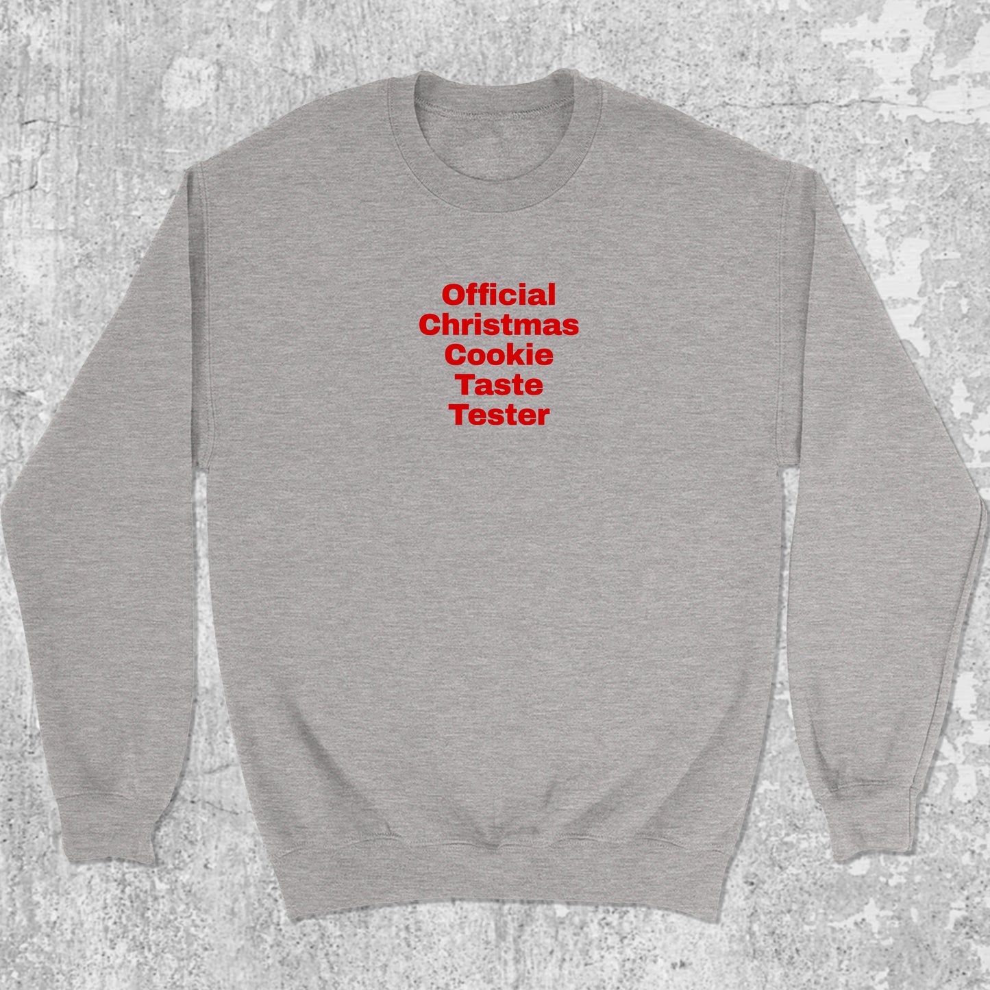 Official Christmas Cookie Taste Tester graphic sweatshirt with bold and humorous print, warm and cozy graphic for everyday wear. Perfect for adults and gift-giving. Heather Grey pullover.