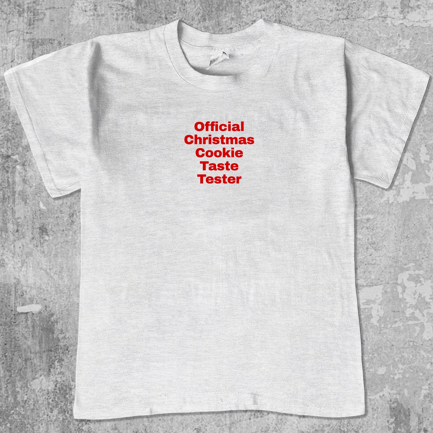 Official Christmas Cookie Taste Tester graphic tee with bold and humorous print, funny and trendy graphic. Perfect for adults and gift-giving. Ash Grey shirt.