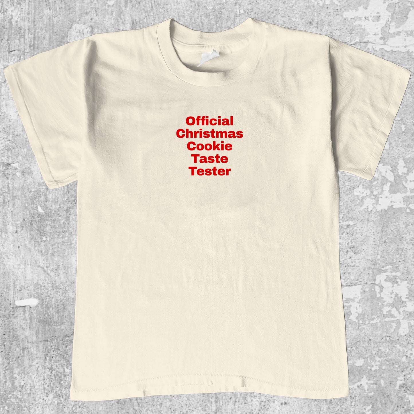 Official Christmas Cookie Taste Tester graphic tee with bold and humorous print, funny and trendy graphic. Perfect for adults and gift-giving. Cream shirt.
