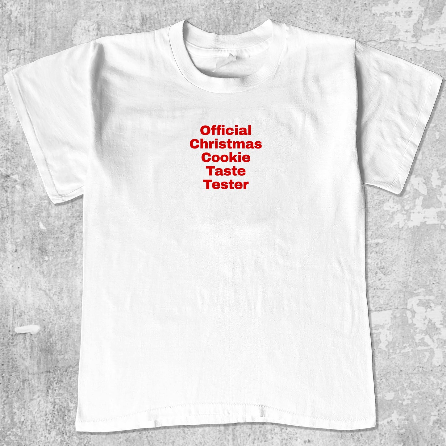 Official Christmas Cookie Taste Tester graphic tee with bold and humorous print, funny and trendy graphic. Perfect for adults and gift-giving. White shirt.