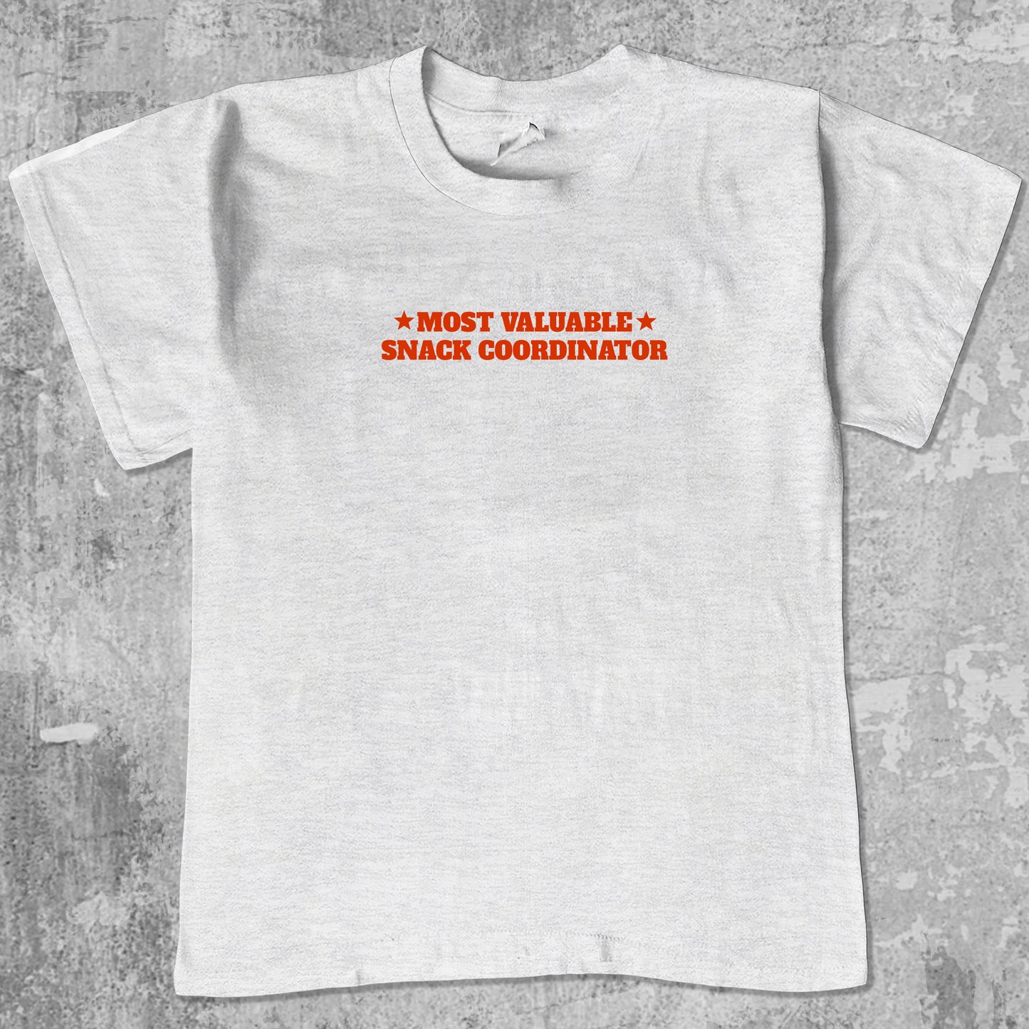 Most valuable snack coordinator graphic tee with bold and humorous print, funny and trendy graphic. Perfect for adults and gift-giving. Ash Grey shirt.