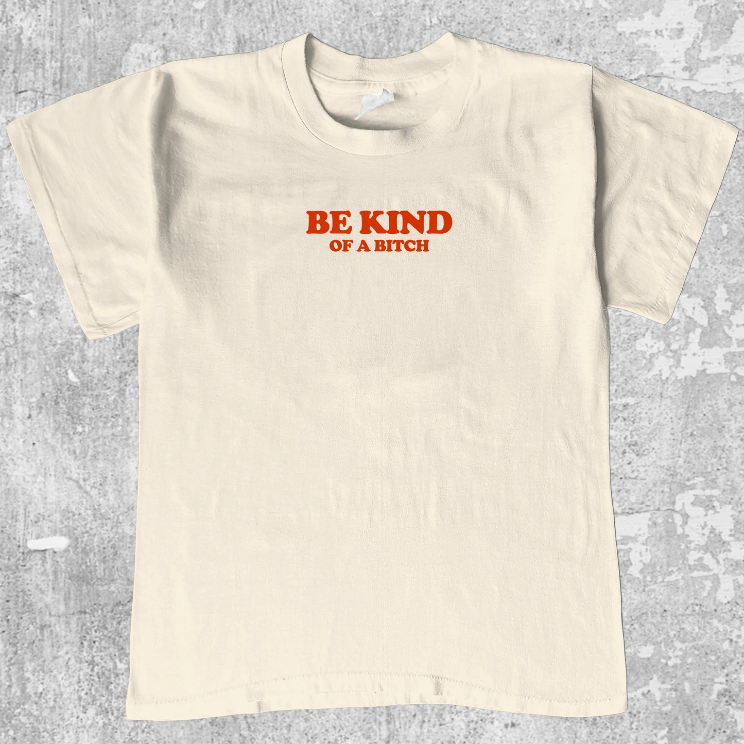 Be Kind Of A Bitch graphic tee with bold and humorous print, funny and trendy graphic. Perfect for adults and gift-giving. Cream shirt.