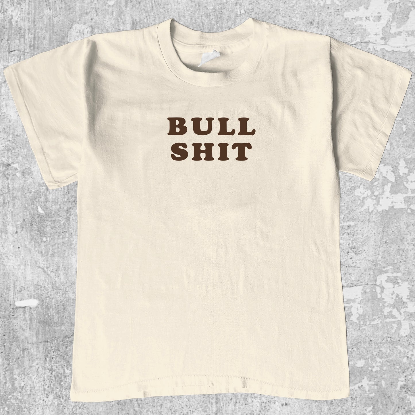 Bull Shit graphic tee with bold and humorous print, funny and trendy graphic. Perfect for adults and gift-giving. Cream shirt.