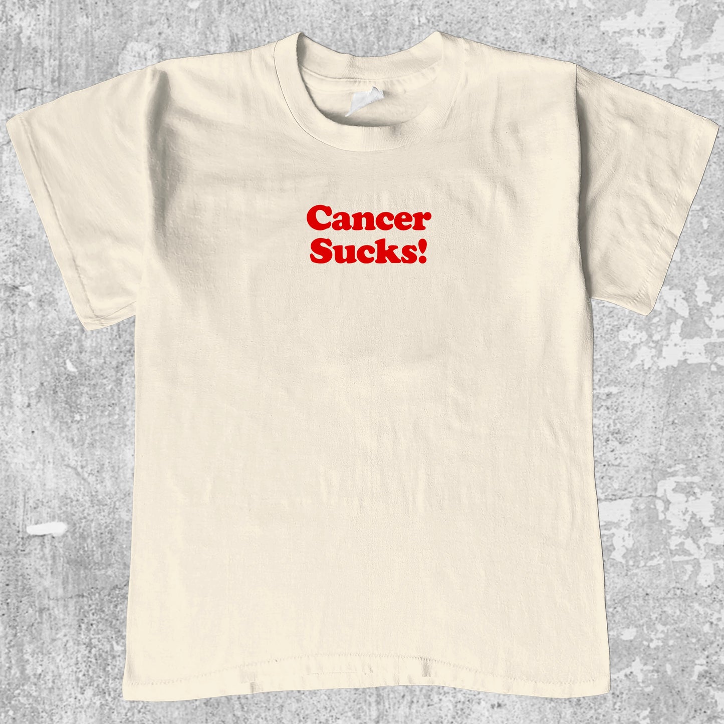 Cancer Sucks graphic tee with funny cancer print, funny and trendy graphic. Perfect for adults and gift-giving. Cream shirt.
