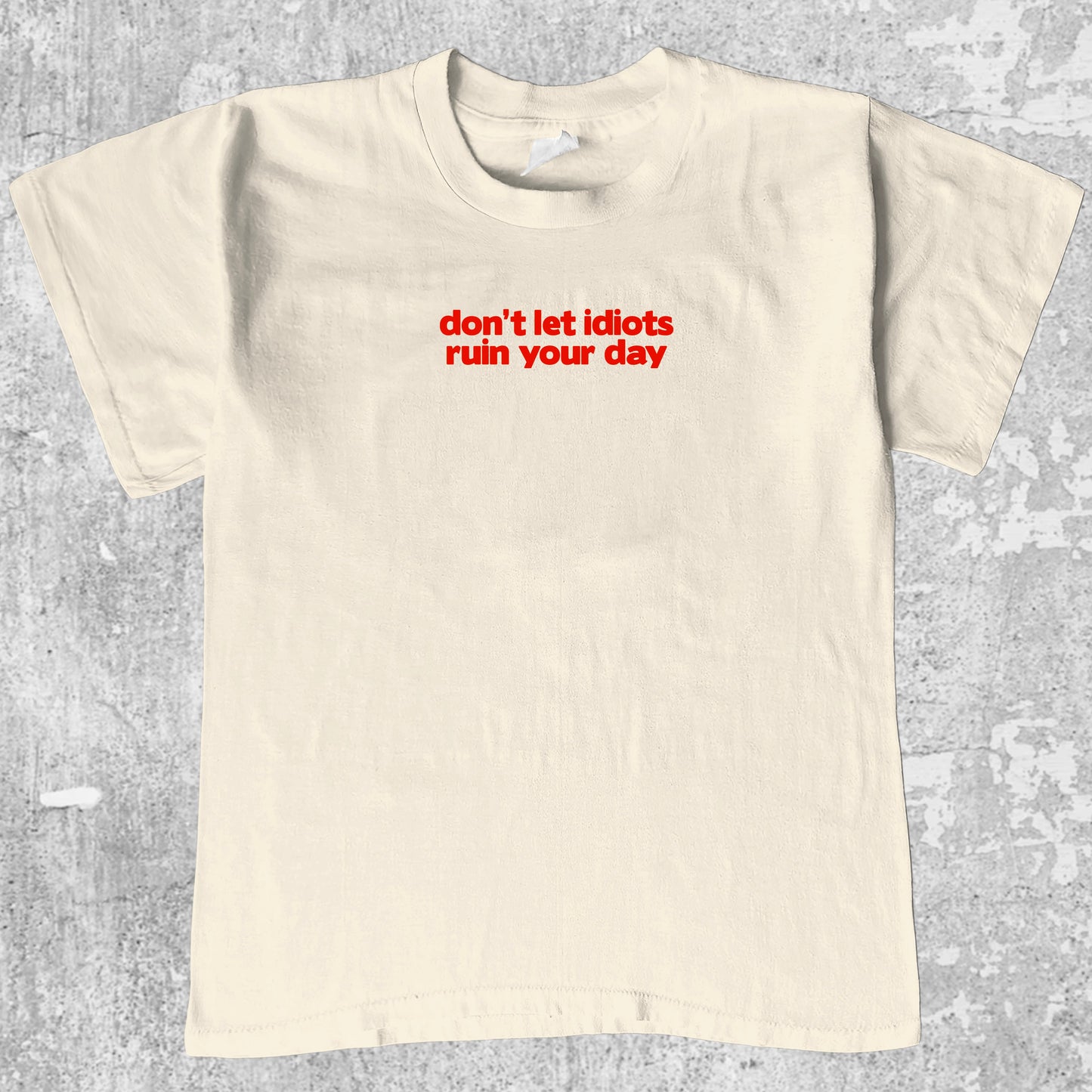 don't let idiots ruin your day graphic tee with bold and humorous print, funny and trendy graphic. Perfect for adults and gift-giving. Cream shirt.