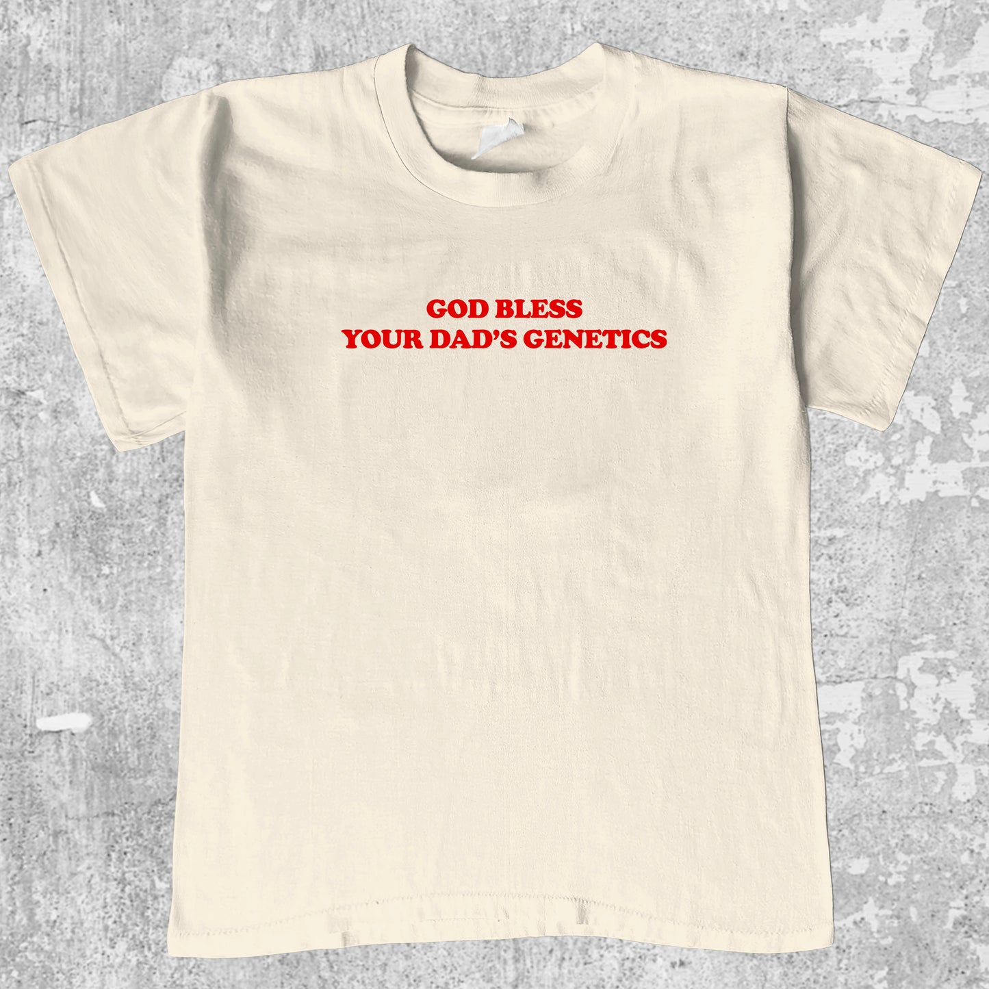 God bless your dad's genetics graphic tee with bold and humorous print, funny and trendy graphic. Perfect for adults and gift-giving. Cream shirt.