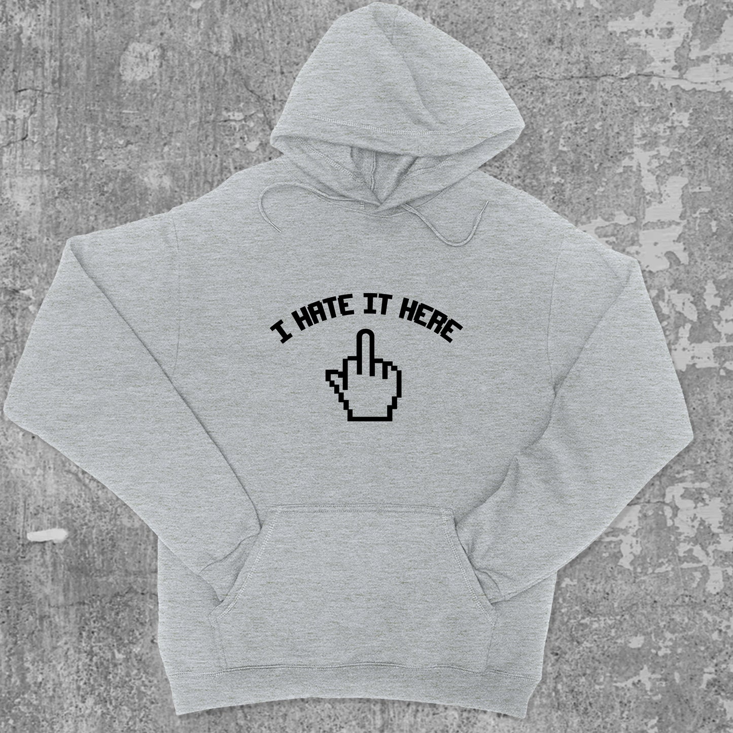 I Hate It Here graphic hoodie with funny and trendy artwork, casual streetwear with bold personality. Great for adults and gifting. Heather Grey hoodie.