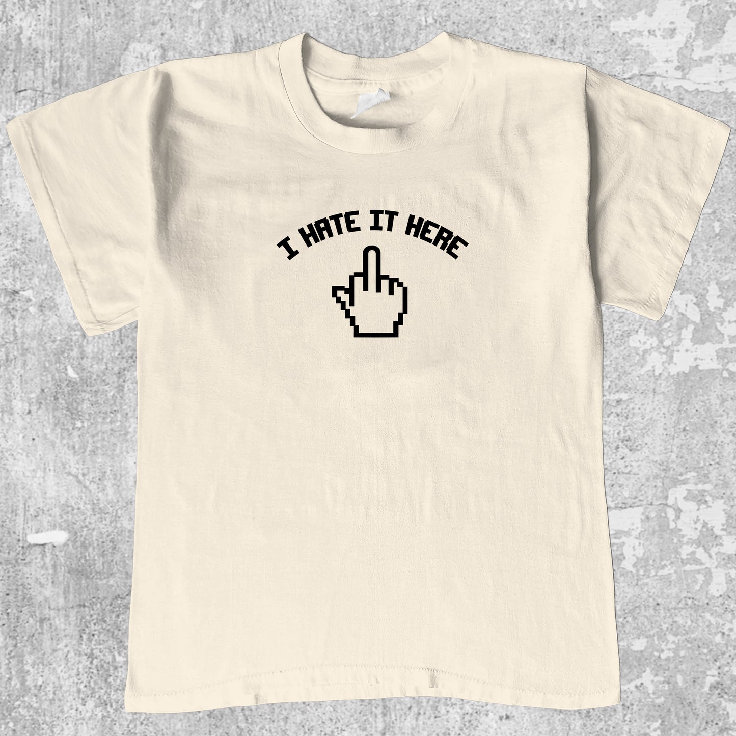 I Hate It Here graphic tee with bold and humorous print, funny and trendy graphic. Perfect for adults and gift-giving. Cream shirt.