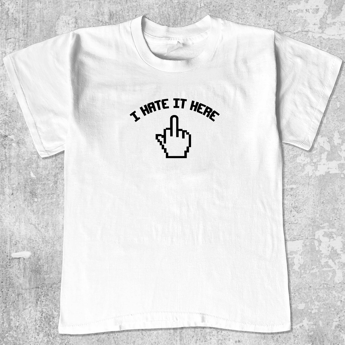 I Hate It Here graphic tee with bold and humorous print, funny and trendy graphic. Perfect for adults and gift-giving. White shirt.