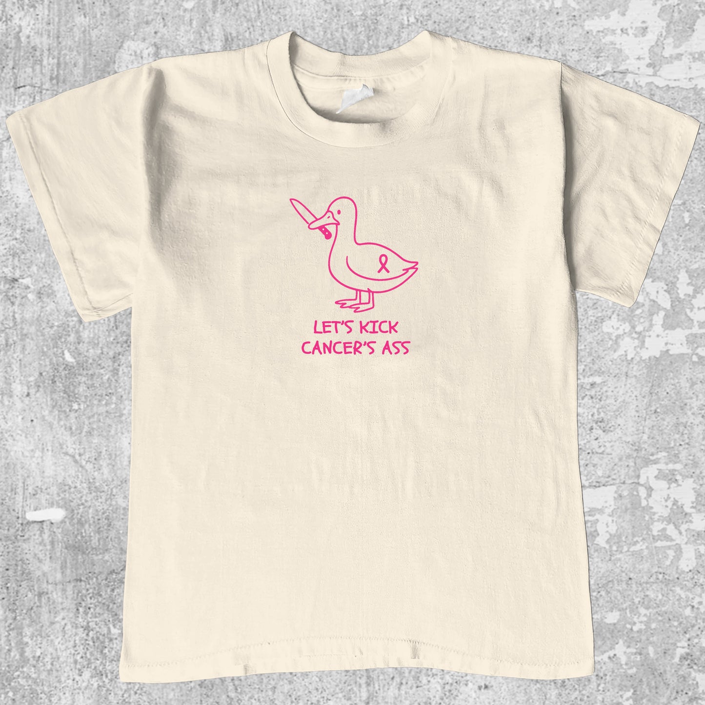 Let's Kick Cancers Ass graphic tee with bold and humorous print, funny and trendy graphic. Perfect for adults and gift-giving. Cream shirt.