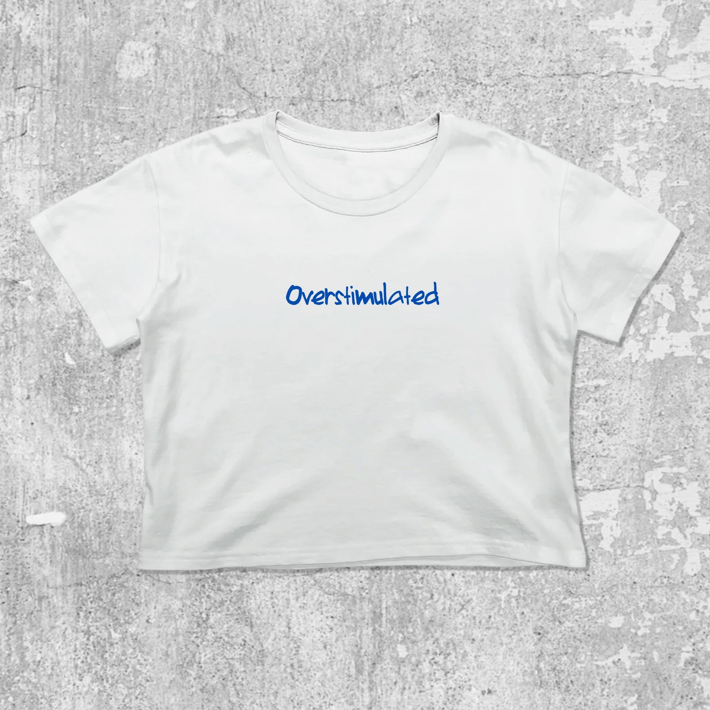 Overstimulated graphic crop tee with cute and trendy fit, featuring playful vintage graphic, stylish cut. White crop t-shirt