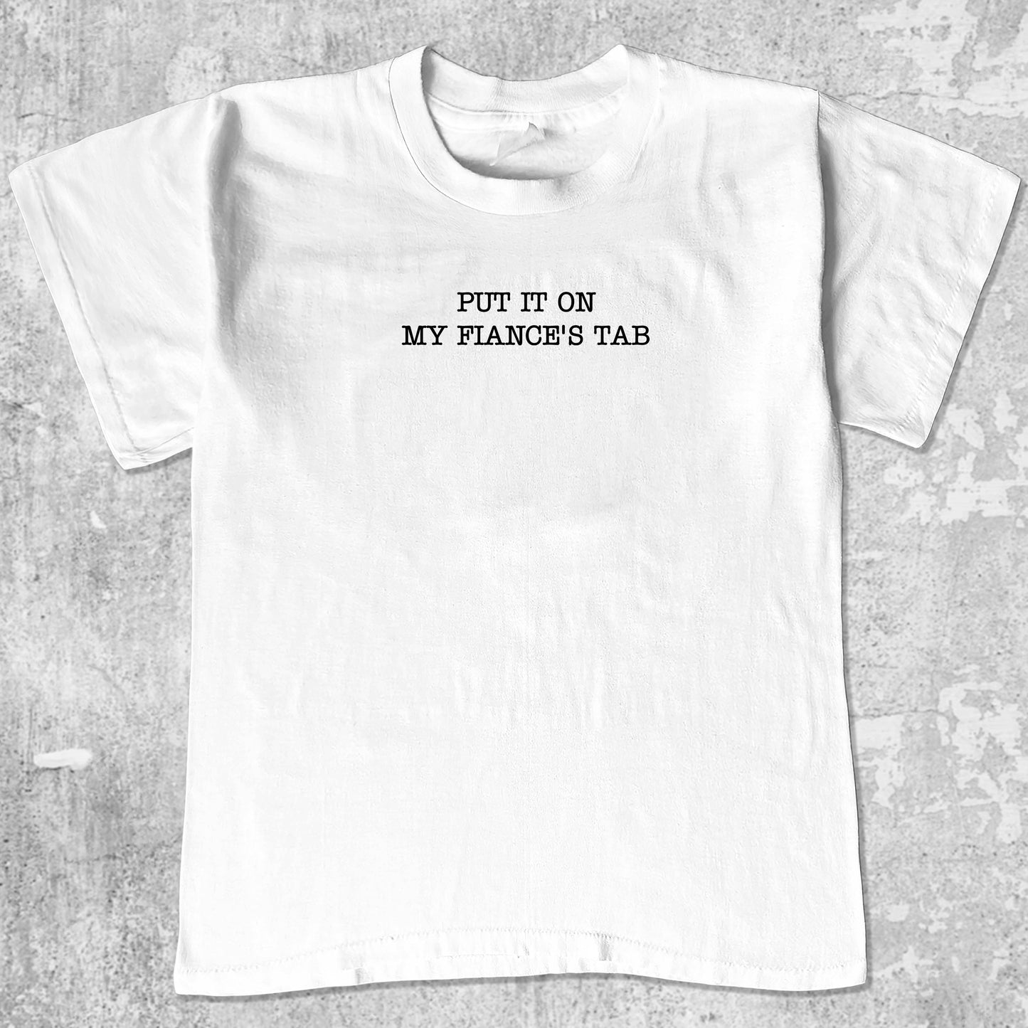 Put It On My Fiance's Tab graphic tee with retro and humorous print, funny and trendy graphic. Perfect for adults and gift-giving. White shirt.