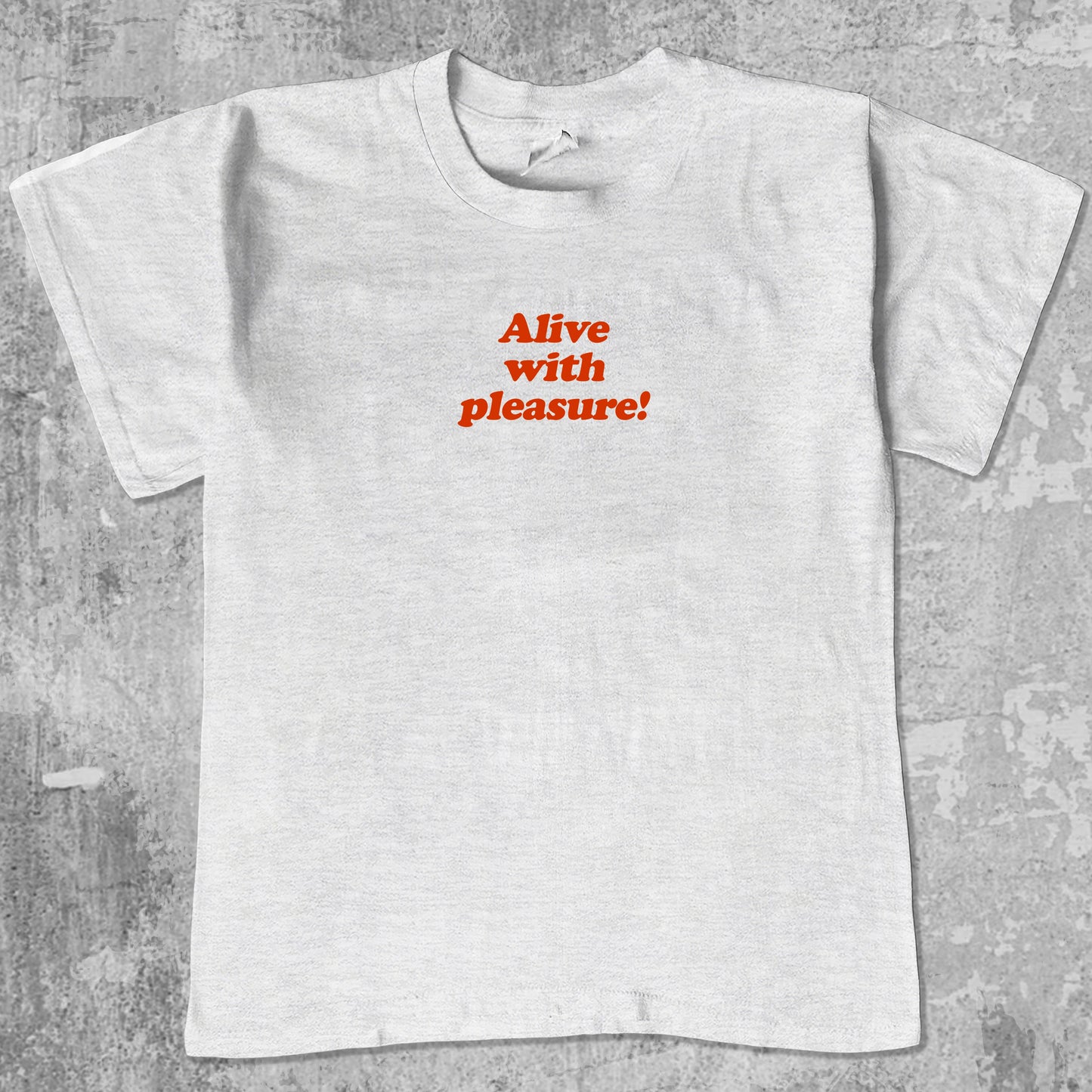 Alive With Pleasure graphic tee with bold and humorous print, funny and trendy graphic. Perfect for adults and gift-giving. Ash Grey shirt.
