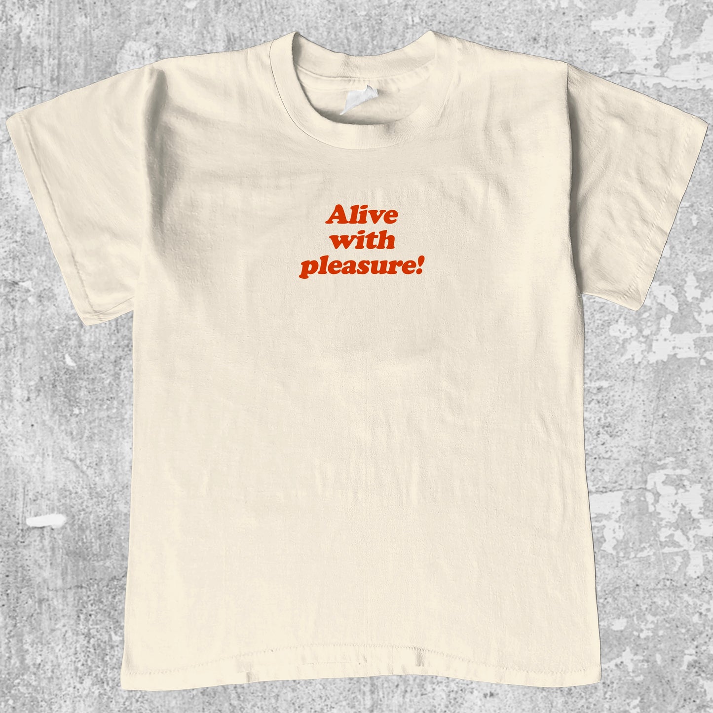 Alive With Pleasure graphic tee with bold and humorous print, funny and trendy graphic. Perfect for adults and gift-giving. Cream shirt.