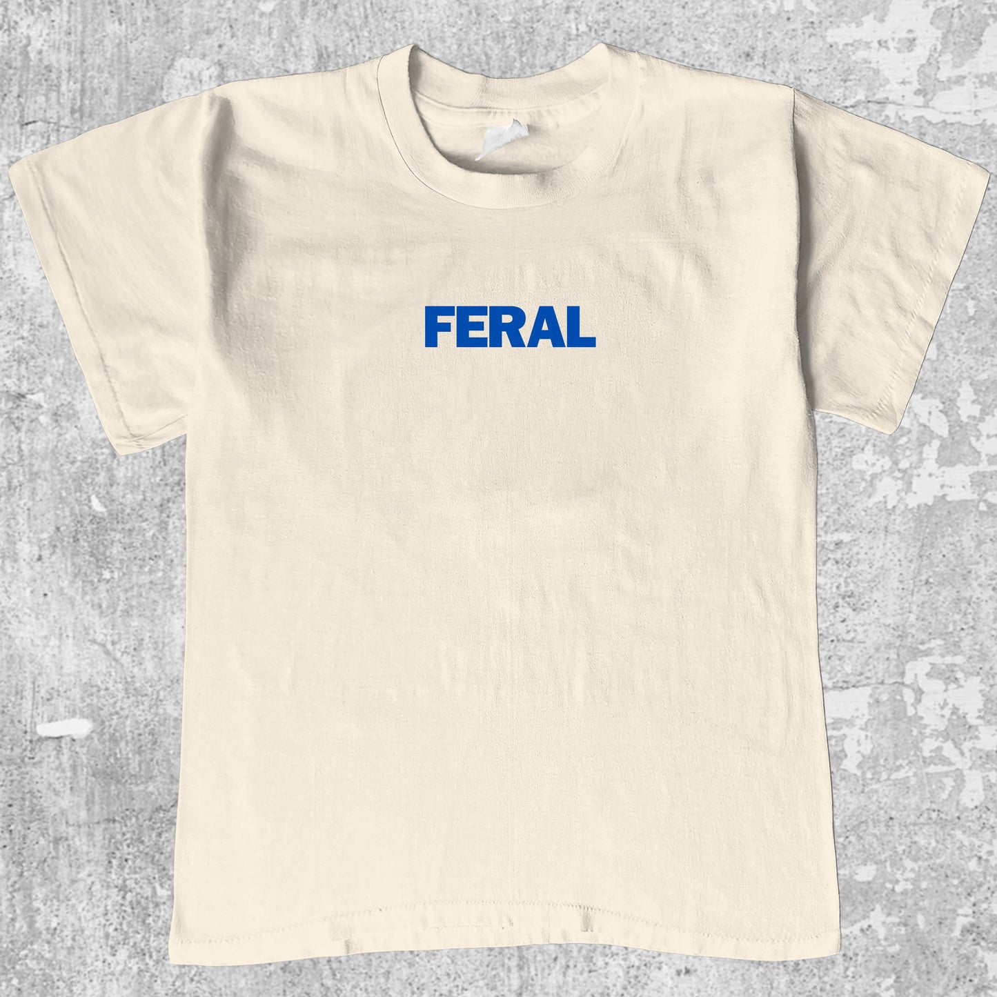 Feral graphic tee with bold and humorous print, funny and simple graphic. Perfect gifts for family and friends. Cream shirt.