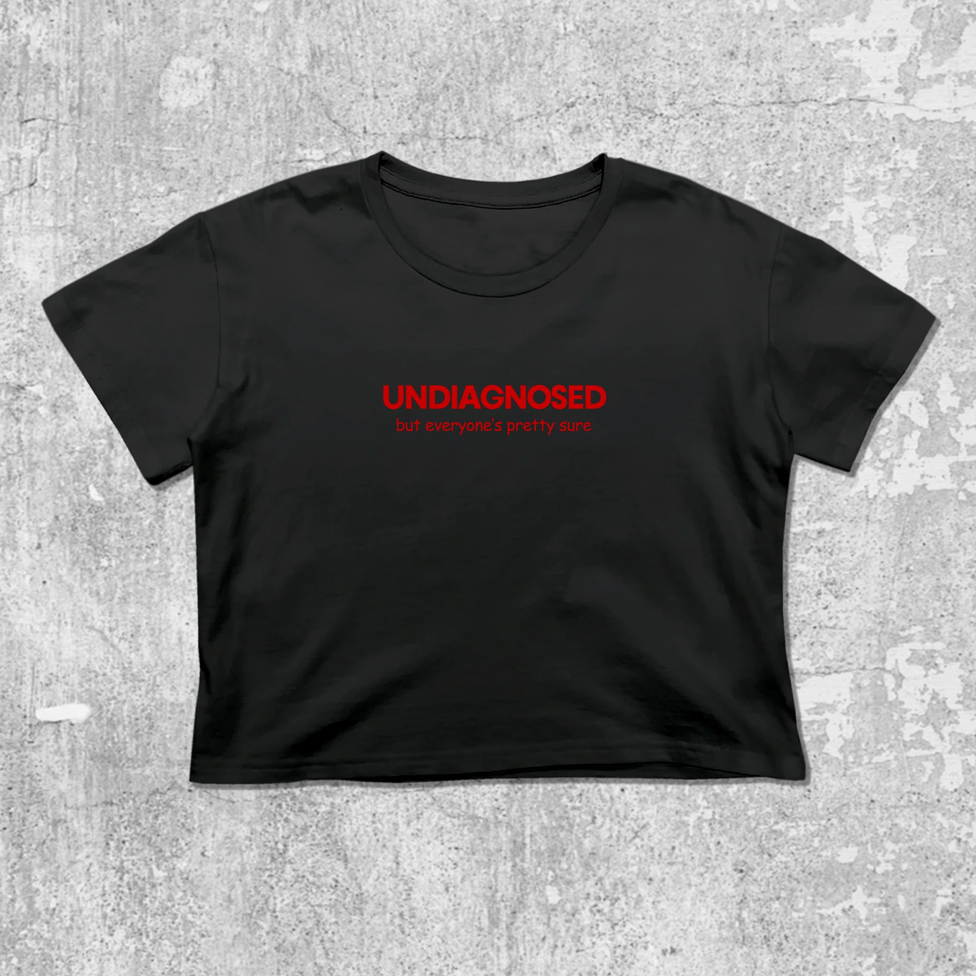 Black t-shirt with red text 'UNDIAGNOSED' on a gray concrete background