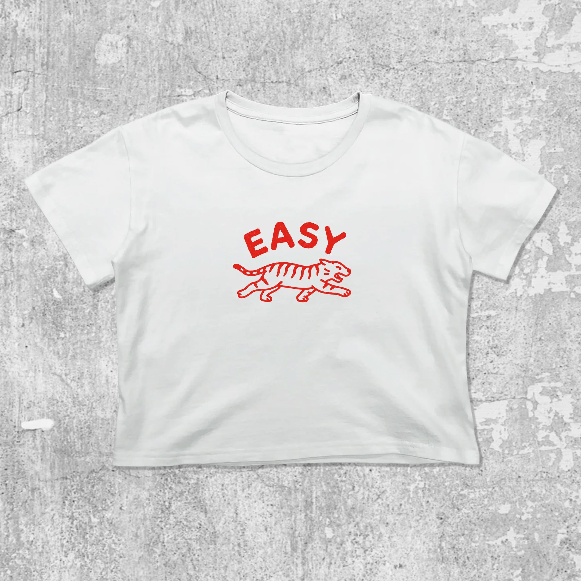Easy Tiger graphic crop tee with cute and trendy fit, featuring playful vintage graphic, stylish cut. White crop t-shirt