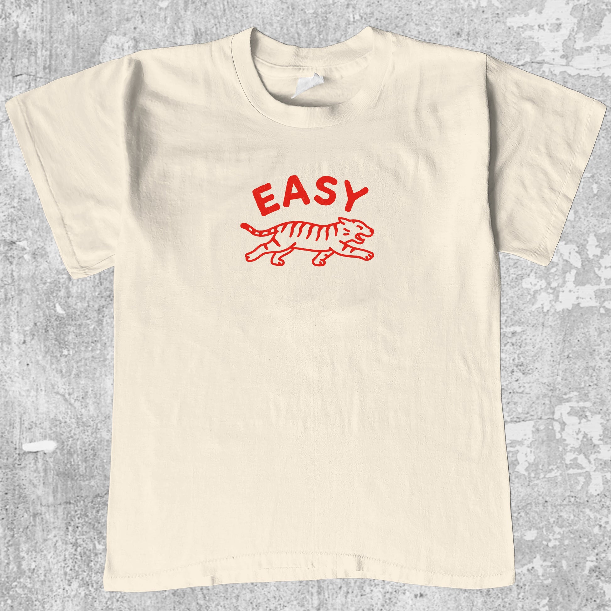 Easy Tiger graphic tee with bold and humorous print, funny and trendy graphic. Perfect gifts for friends and family. Cream shirt.