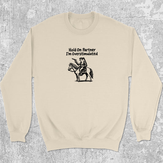 Hold On Partner I'm Overstimulated graphic sweatshirt with funny frogs print, warm and cozy graphic for everyday wear. Perfect for Christmas gifts for friends and family. Natural pullover.