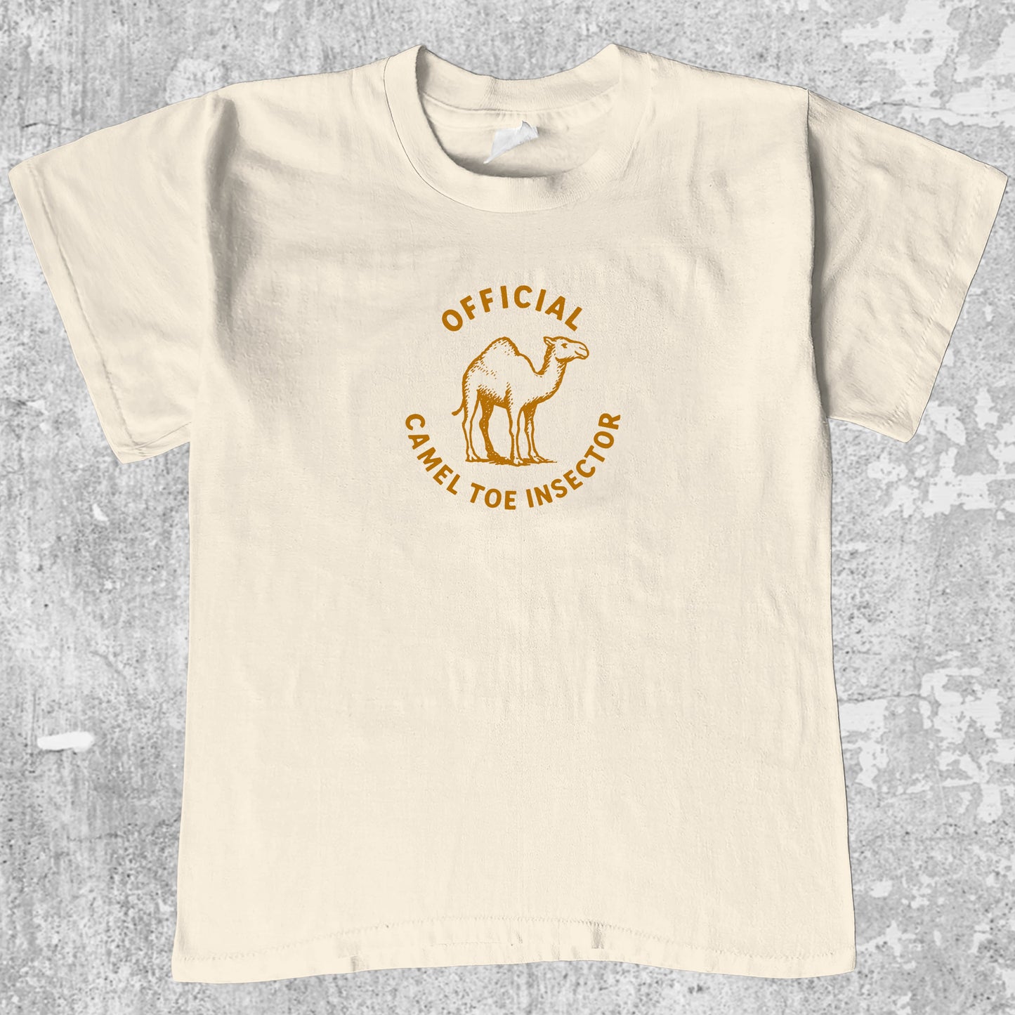 Official Camel Toe Inspector graphic tee with bold and humorous print, funny and trendy graphic. Perfect for adults and gift-giving. Cream shirt.