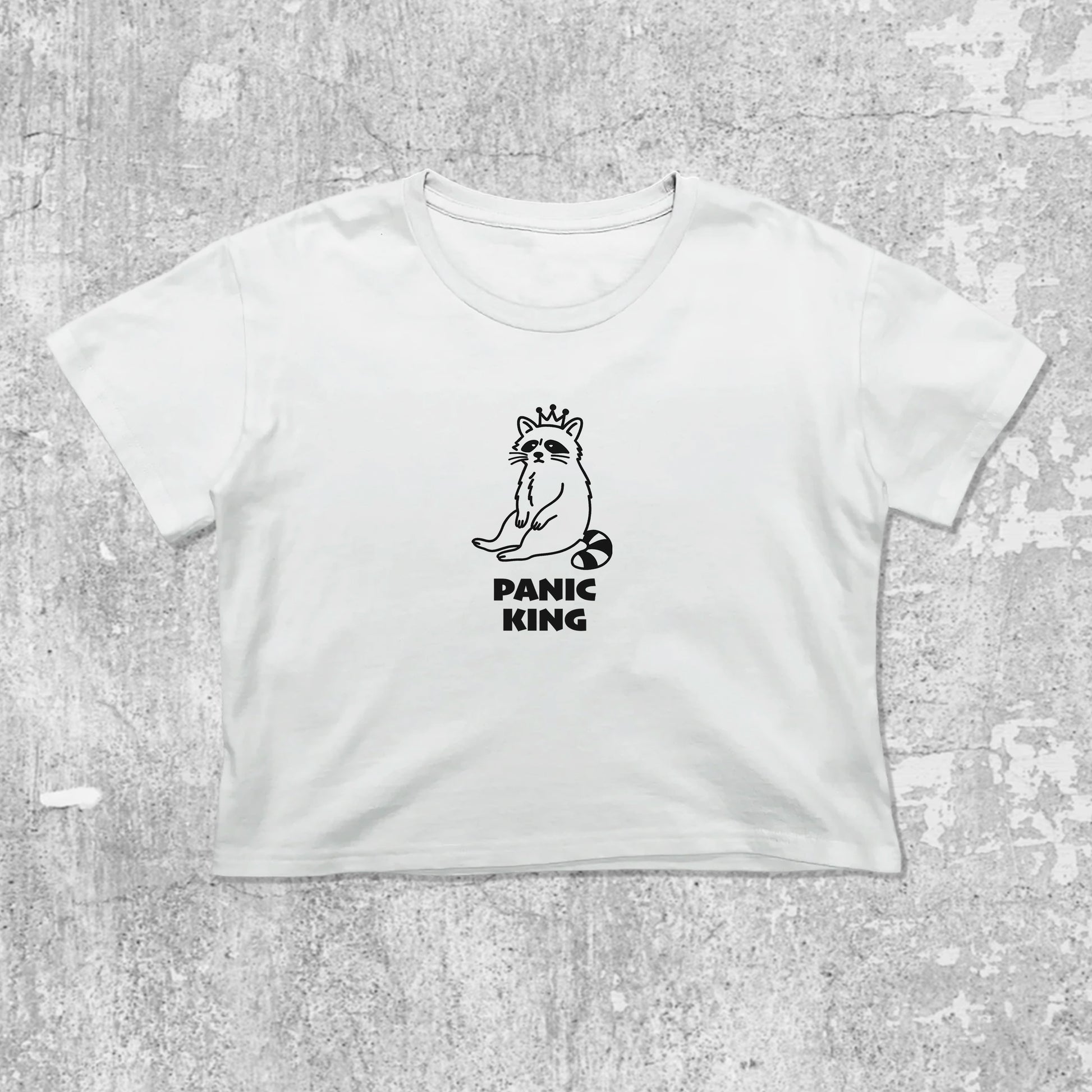 Panic King Raccoon graphic crop tee with cute and trendy fit, featuring playful vintage graphic, stylish cut. White crop t-shirt