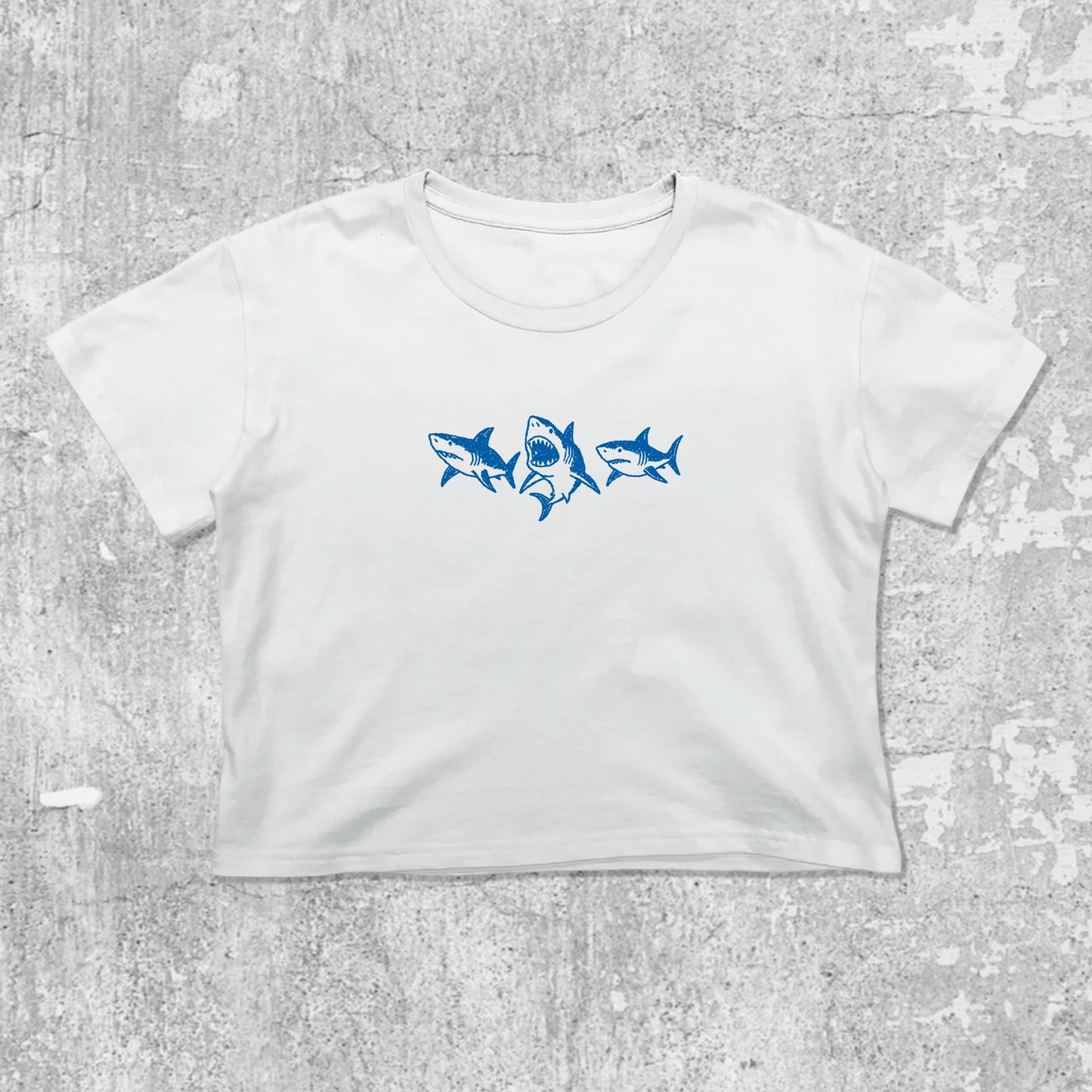 Sharks graphic crop tee with cute and trendy fit, featuring playful vintage graphic, stylish cut. White crop t-shirt