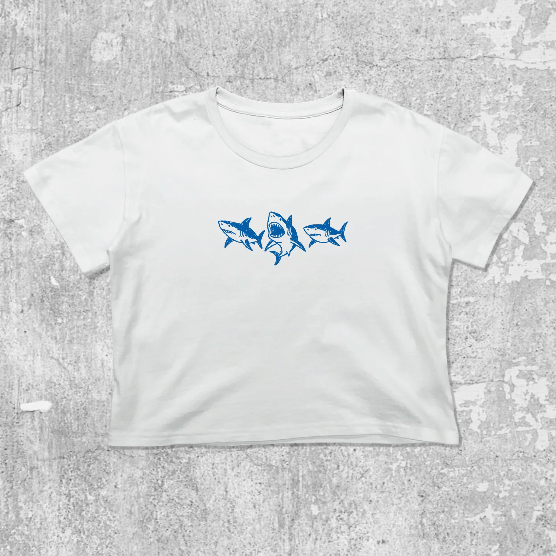 Sharks graphic crop tee with cute and trendy fit, featuring playful vintage graphic, stylish cut. White crop t-shirt