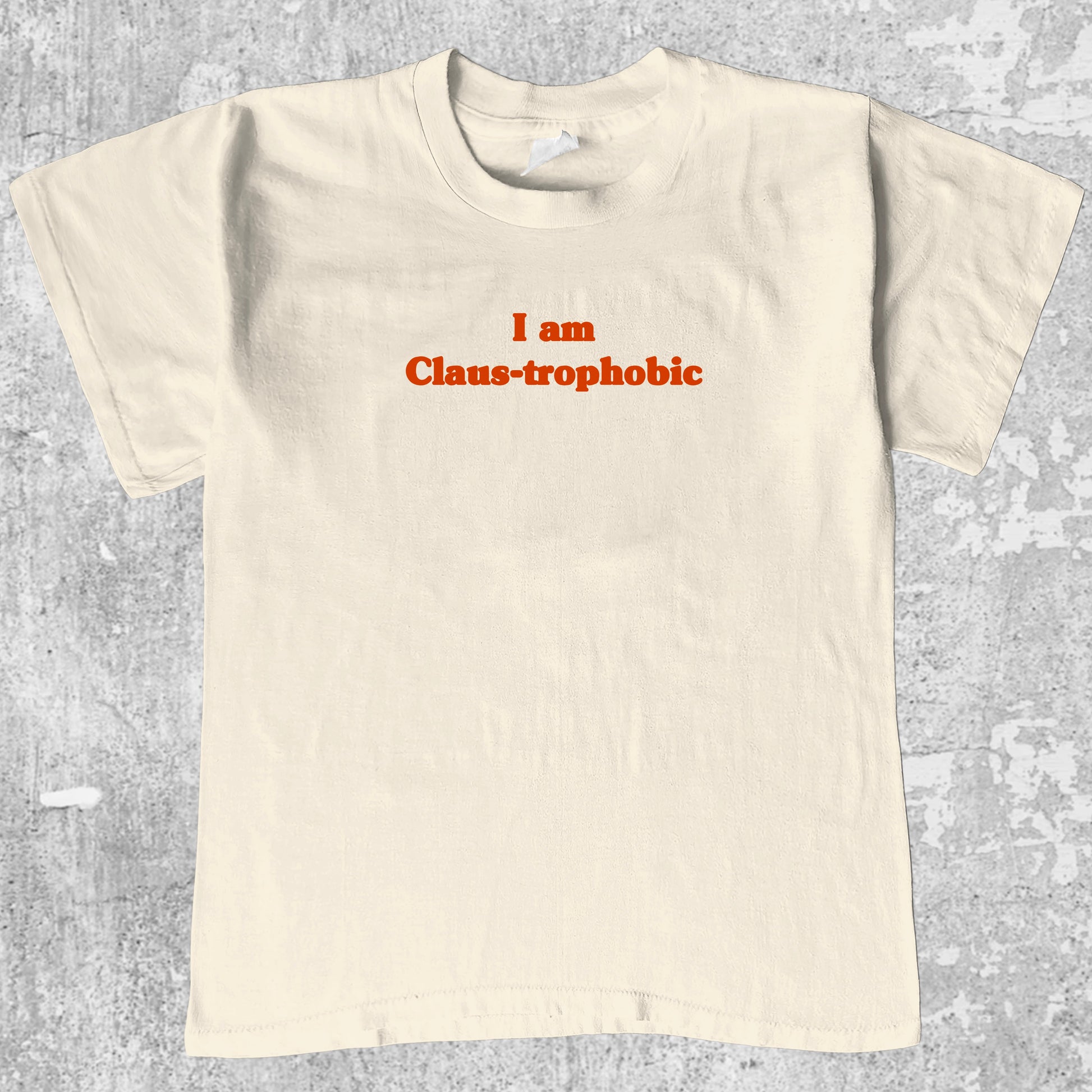I'm Claus-trophobic graphic tee with cute and humorous print, funny and Vintage graphic. Perfect for christmas gifts. Cream shirt.