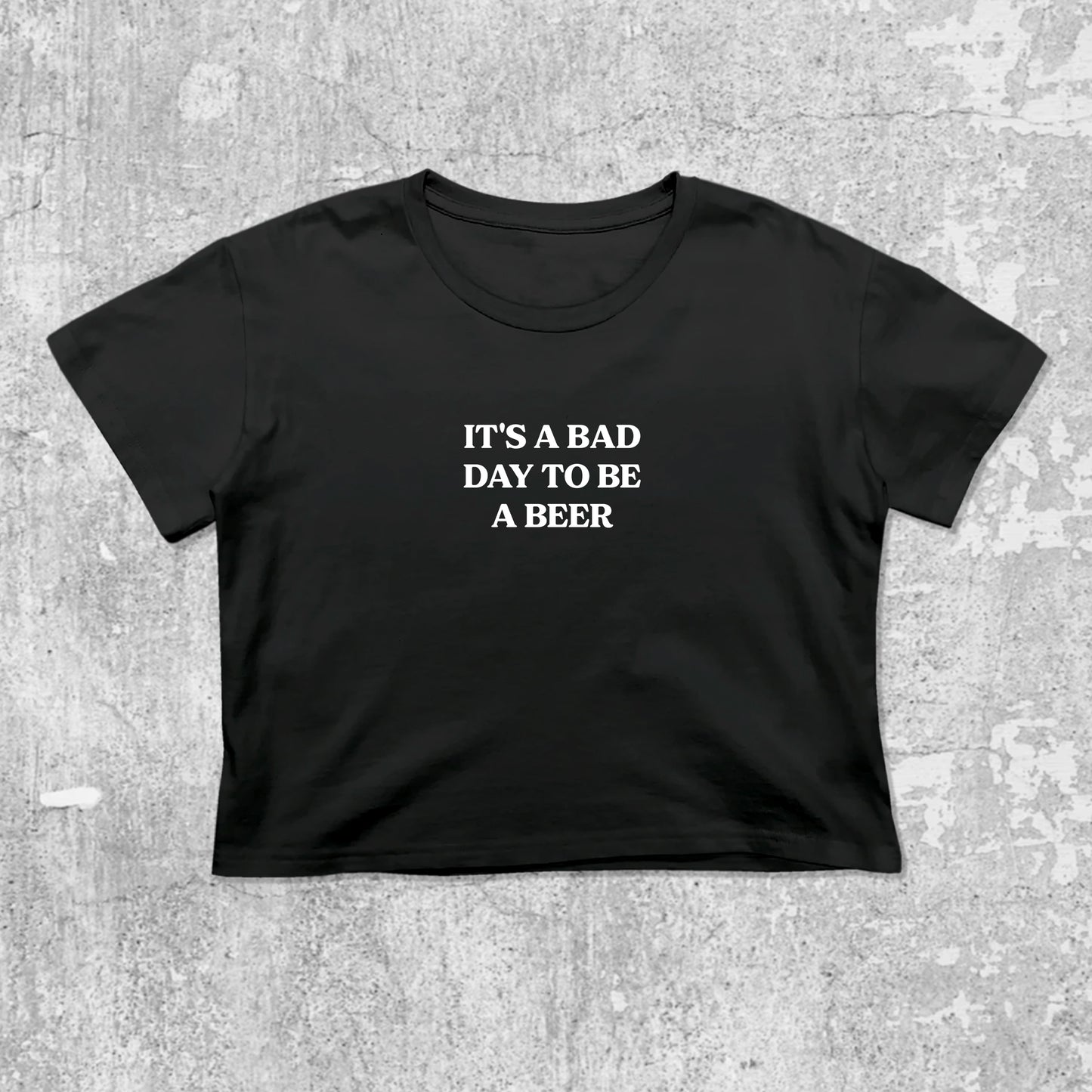 It's A Bad Day To Be A Beer graphic crop tee with cute and trendy fit, featuring playful vintage graphic, stylish cut. Black crop t-shirt