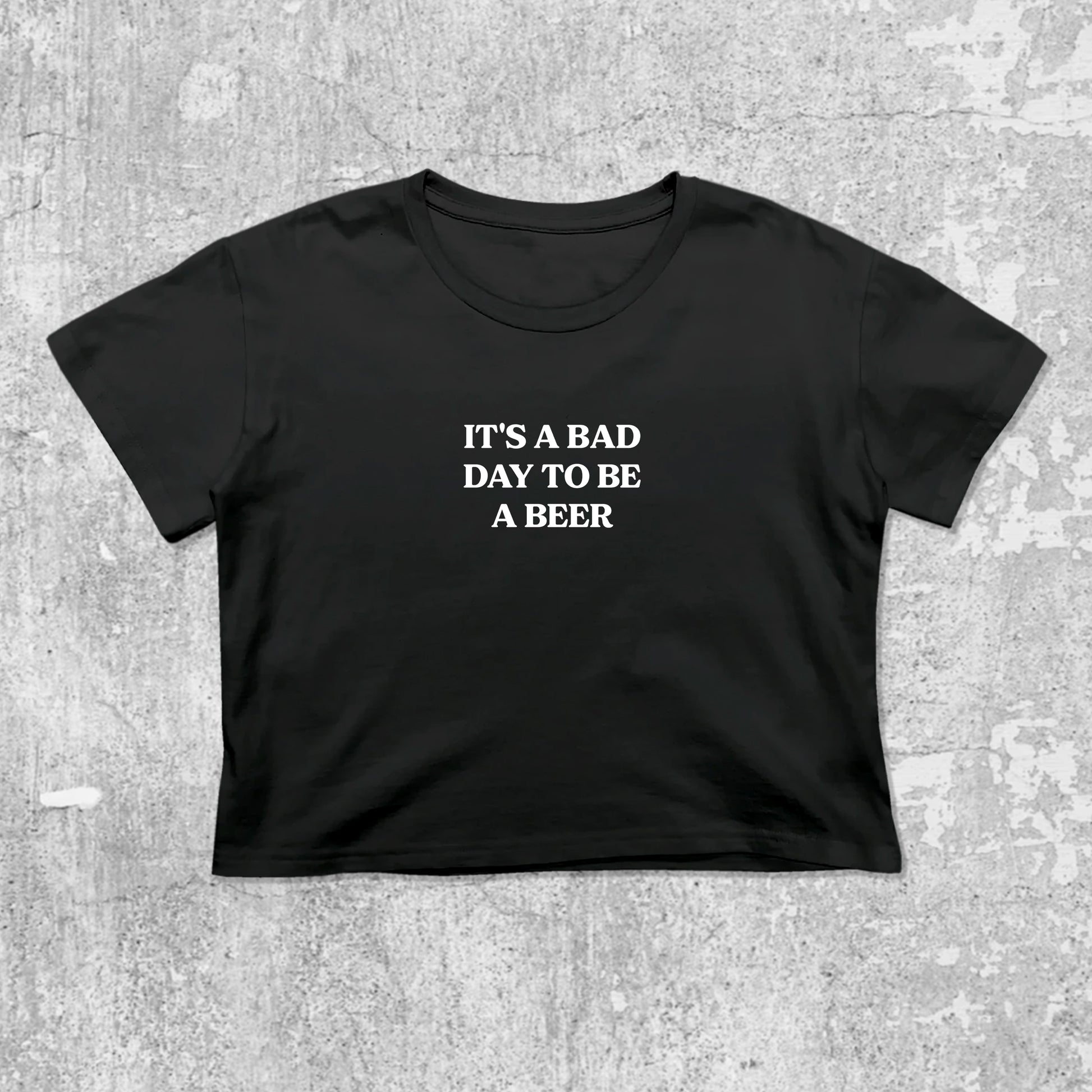 It's A Bad Day To Be A Beer graphic crop tee with cute and trendy fit, featuring playful vintage graphic, stylish cut. Black crop t-shirt