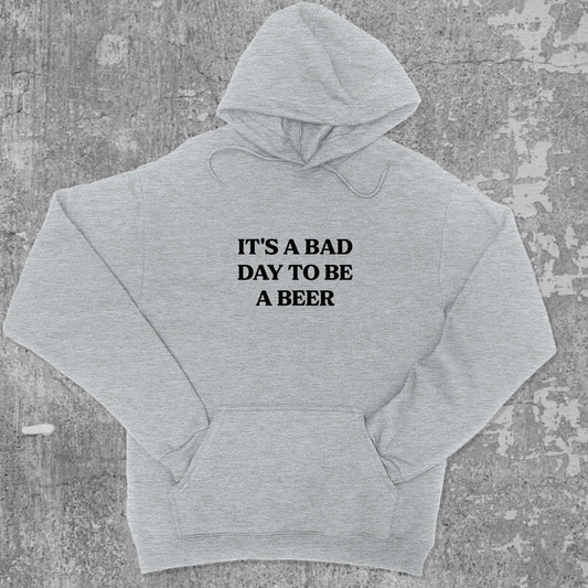 It's A Bad Day To Be A Beer graphic hoodie with funny and trendy artwork, casual streetwear with bold personality. Great for adults and gifting. Heather Grey hoodie.
