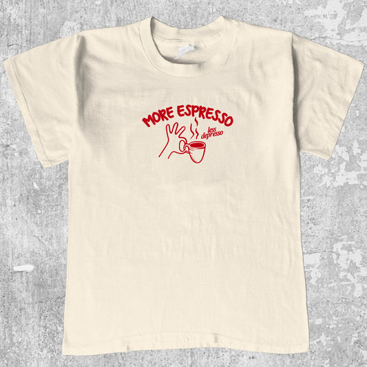More Espresso Less Depresso graphic tee with retro coffee print, funny and trendy graphic. Perfect for friends. Cream shirt.