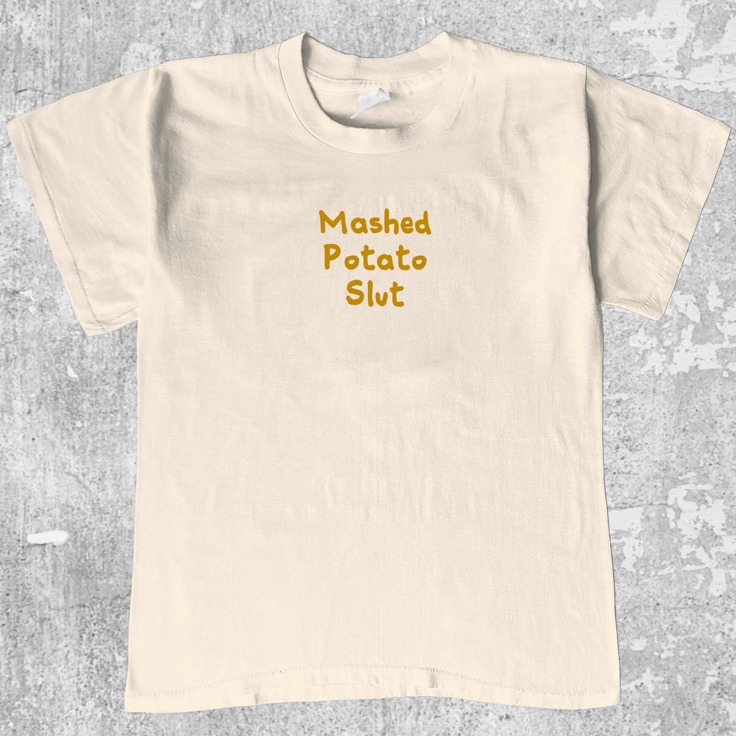Mashed Potato Slut graphic tee with bold and humorous print, funny and trendy graphic. Perfect for Christmas gifts for friends and family. Cream shirt.