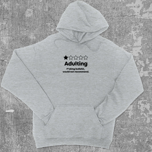 Adulting graphic hoodie with funny and trendy artwork, casual streetwear with bold personality. Great for adults and gifting. Heather Grey hoodie.