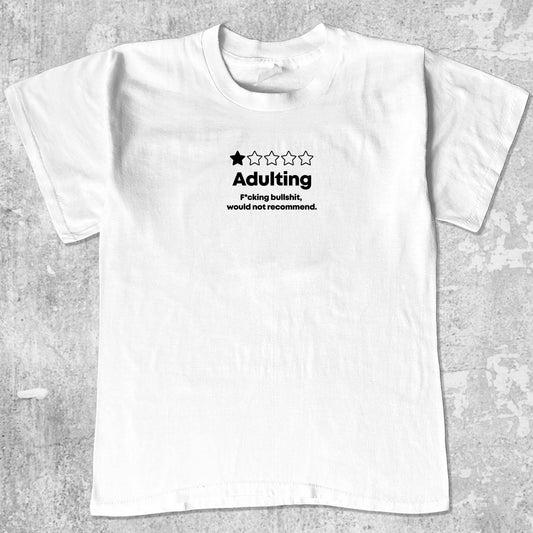 Adulting graphic tee with bold and humorous print, funny and trendy graphic. Perfect for adults and gift-giving. White shirt.