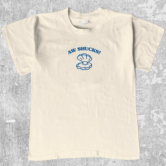 Aw Shucks graphic tee with bold and humorous print, funny and trendy graphic. Perfect for adults and gift-giving. Cream shirt.