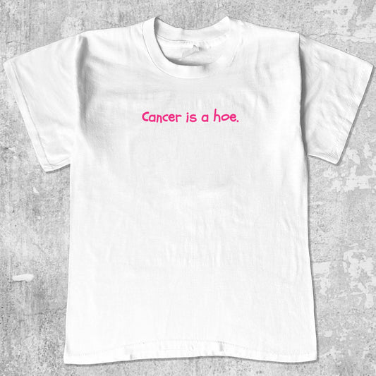 Cancer Is A Hoe graphic tee with breast cancer awareness graphic, funny and trendy graphic. Perfect for adults and gift-giving. White shirt.