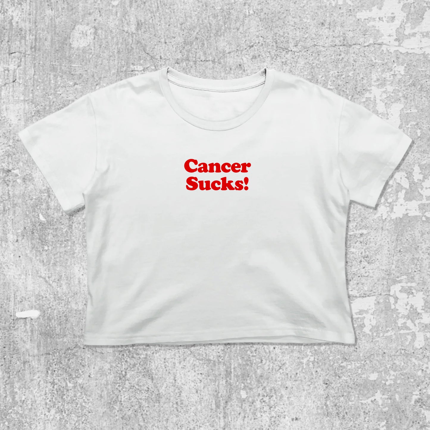 Cancer Sucks graphic crop tee with cute and trendy fit, featuring playful vintage graphic, stylish cut. White crop t-shirt