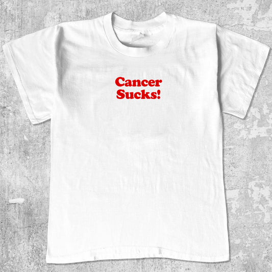 Cancer Sucks graphic tee with funny cancer print, funny and trendy graphic. Perfect for adults and gift-giving. White shirt.
