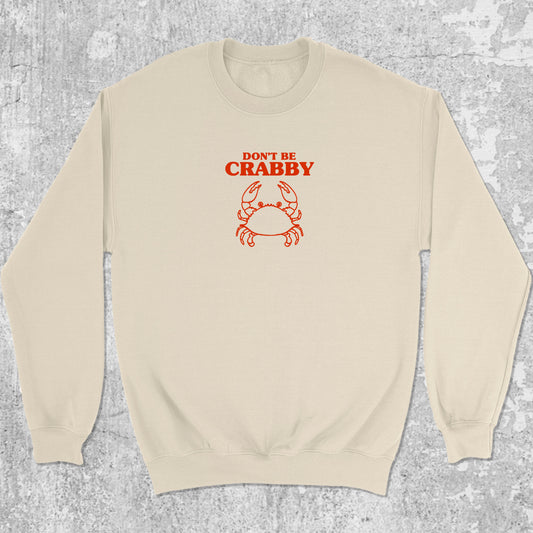 Don't Be Crabby graphic sweatshirt with bold and humorous print, warm and cozy graphic for everyday wear. Perfect for adults and gift-giving. Natural pullover.