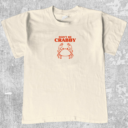 Don't Be Crabby graphic tee with bold and humorous print, funny and trendy graphic. Perfect for adults and gift-giving. Cream shirt.