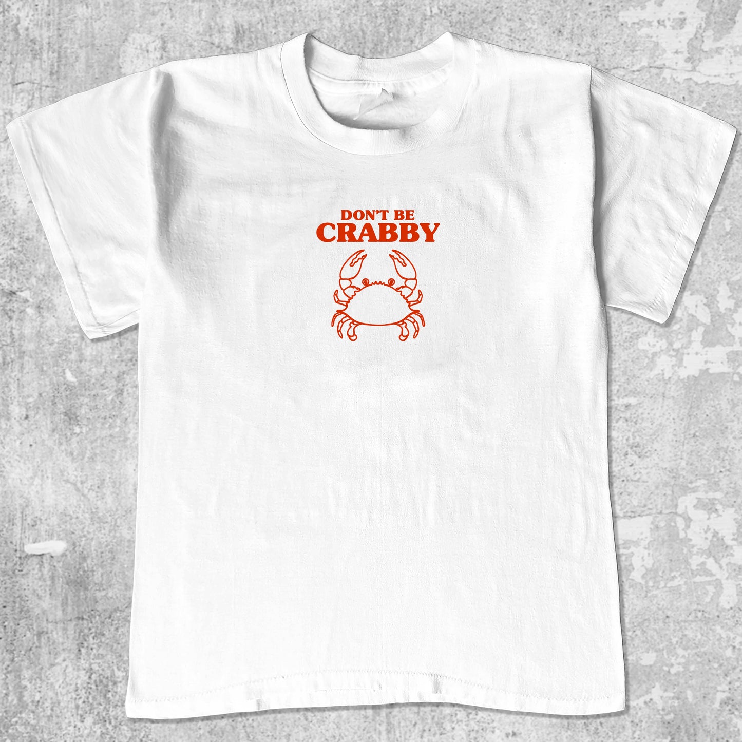 Don't Be Crabby graphic tee with bold and humorous print, funny and trendy graphic. Perfect for adults and gift-giving. White shirt.