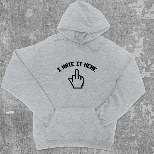 I Hate It Here graphic hoodie with funny and trendy artwork, casual streetwear with bold personality. Great for adults and gifting. Heather Grey hoodie.