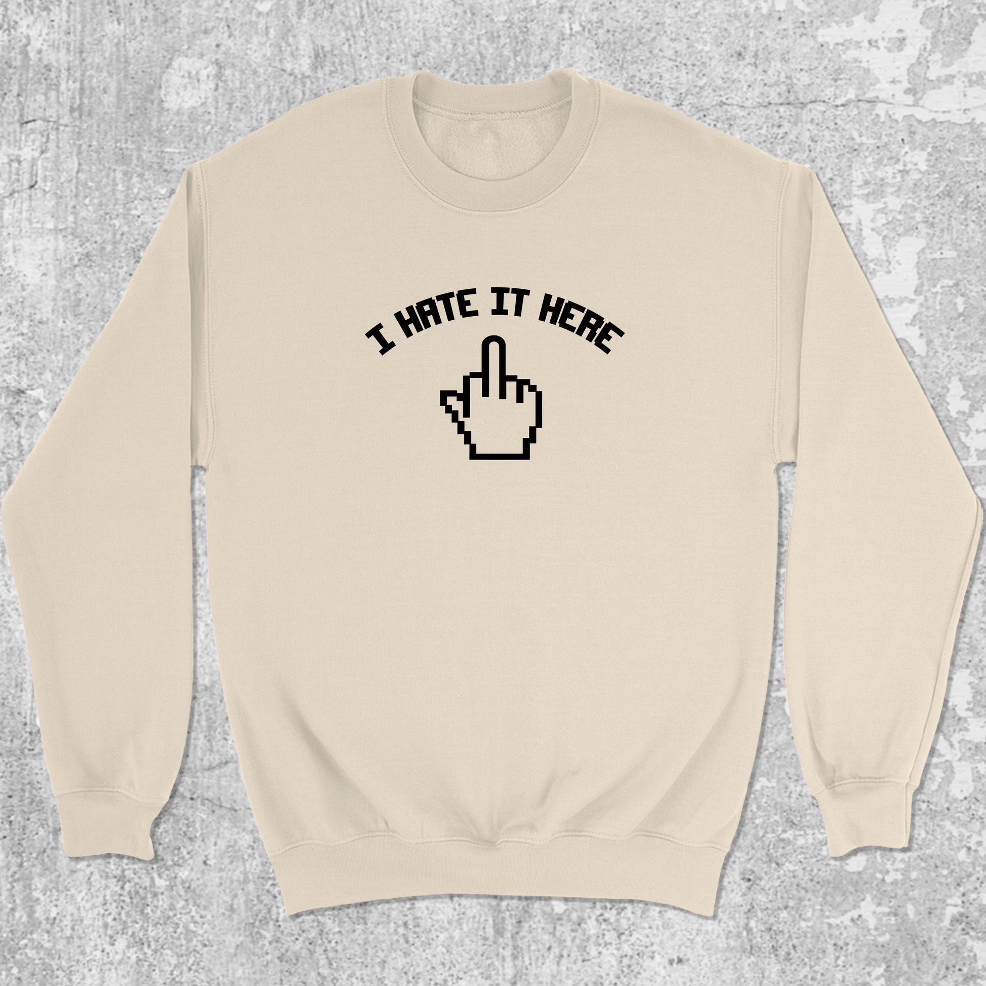 I Hate It Here graphic sweatshirt with bold and humorous print, warm and cozy graphic for everyday wear. Perfect for adults and gift-giving. Natural pullover.