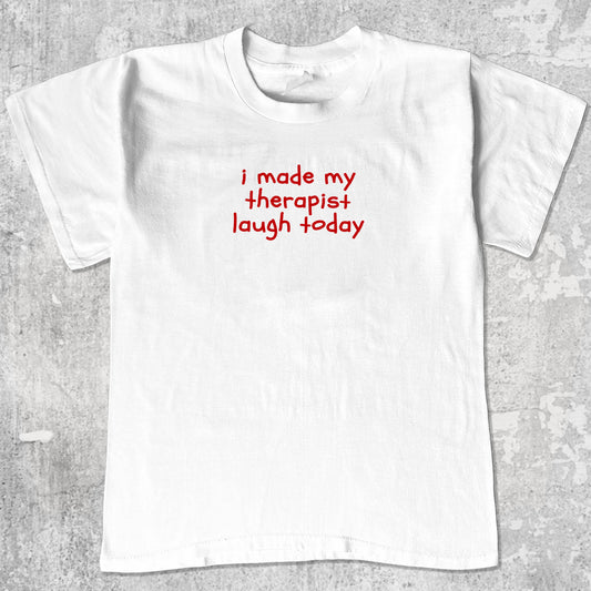 I Made My Therapist Laugh Today graphic tee with cute and humorous print, funny and Vintage graphic. Perfect for friends. White shirt.