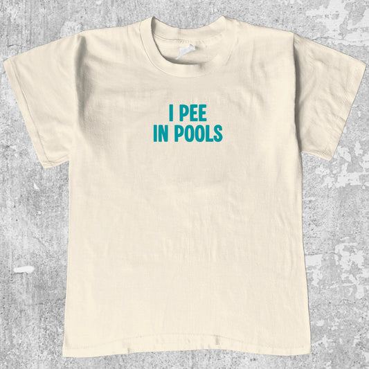 Pee In Pools graphic tee retro and funny graphic, funny and trendy graphic. Perfect for adults and gift-giving. Cream shirt.