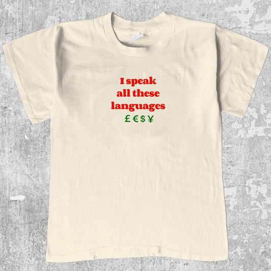 I speak all these languages graphic tee with bold and humorous print, funny and trendy graphic. Perfect for adults and gift-giving. Cream shirt.