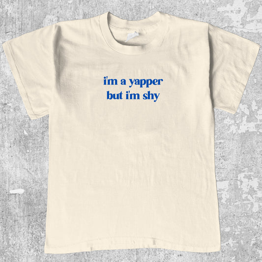 I'm A Yapper But I'm Shy graphic tee with bold and humorous print, funny and trendy graphic. Perfect gifts for friends and family. Cream shirt.